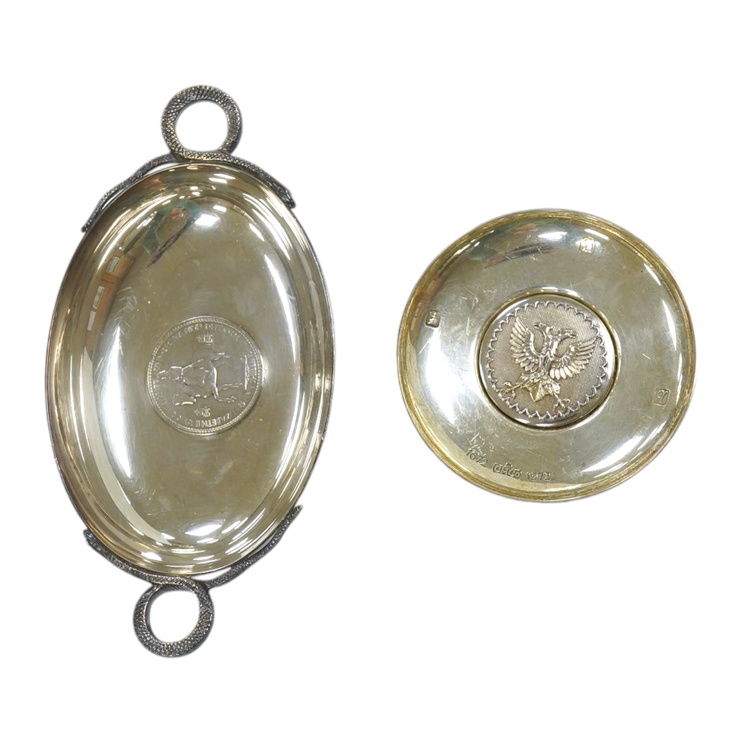 A 1970's Brittania standard silver commemorative small dish, C. Hoare & Co, London, 1972, 92mm, together with a German 925 oval dish with serpent handles and inset with coin, gross 8.9oz. Condition - fair